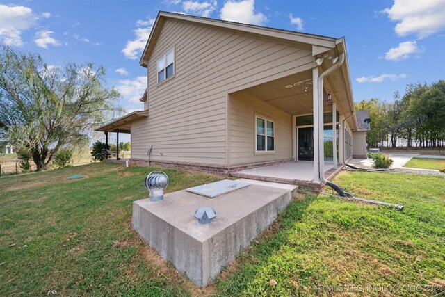 rear view of house with a yard and a patio