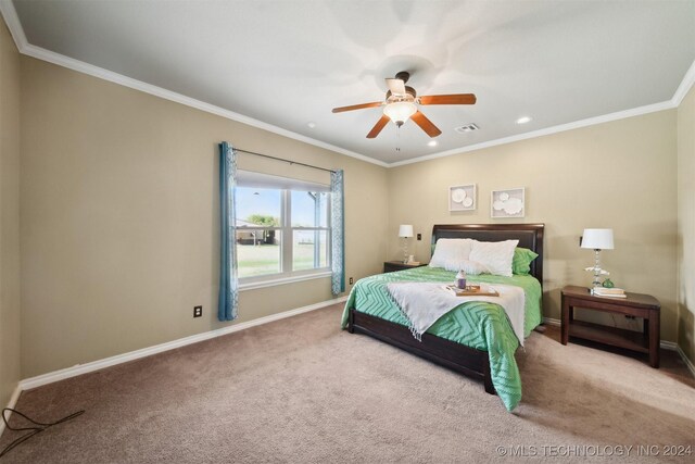 bedroom featuring ceiling fan, ornamental molding, and light carpet