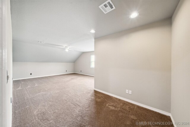 additional living space with carpet flooring, vaulted ceiling, and ceiling fan