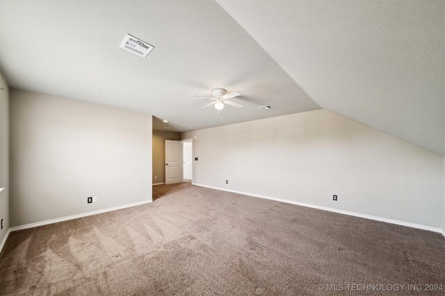 additional living space with carpet, ceiling fan, and vaulted ceiling