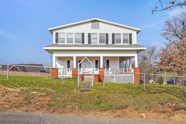 view of front of house with a front yard and covered porch