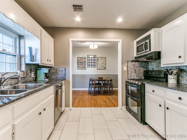 kitchen with light wood-type flooring, range hood, sink, appliances with stainless steel finishes, and white cabinets