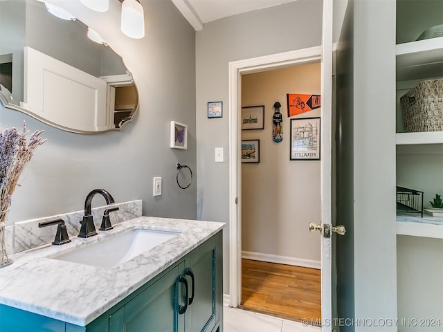 bathroom with vanity and hardwood / wood-style flooring