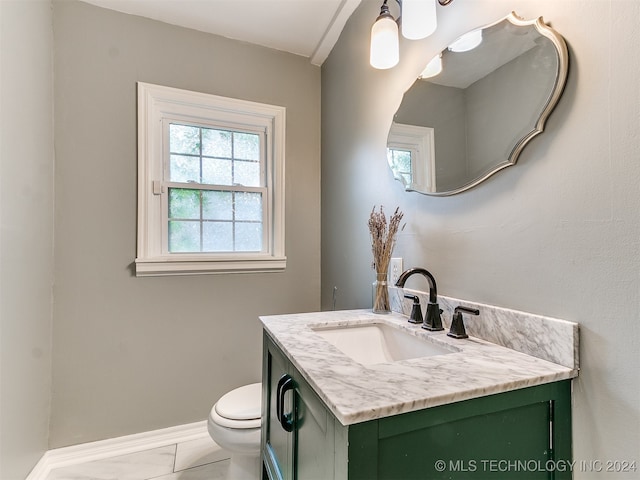 bathroom featuring vanity and toilet