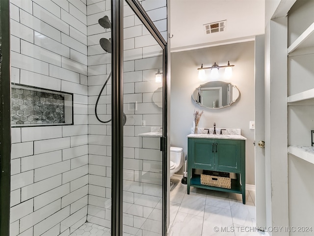 bathroom featuring a shower with door, vanity, and toilet