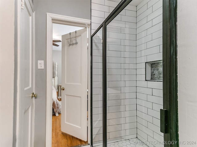 bathroom featuring walk in shower and hardwood / wood-style flooring