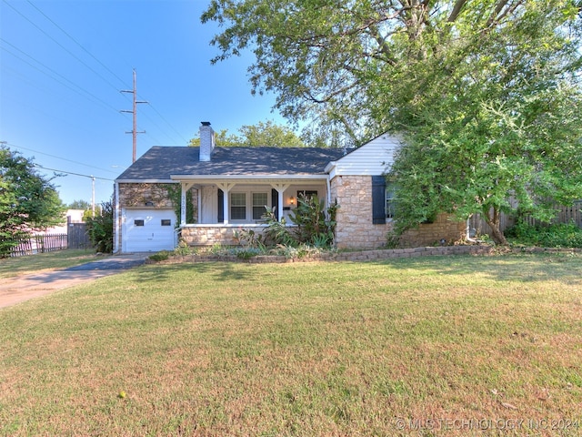 view of front facade with a garage, a front yard, and a porch