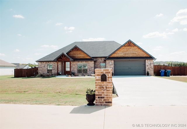 view of front of home with a garage and a front lawn