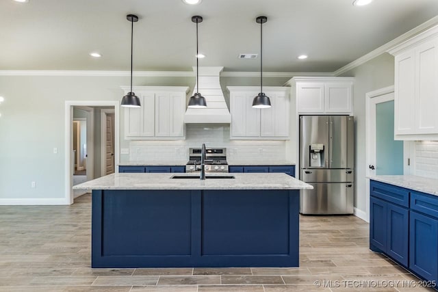 kitchen featuring sink, a kitchen island with sink, stainless steel appliances, light stone countertops, and decorative light fixtures