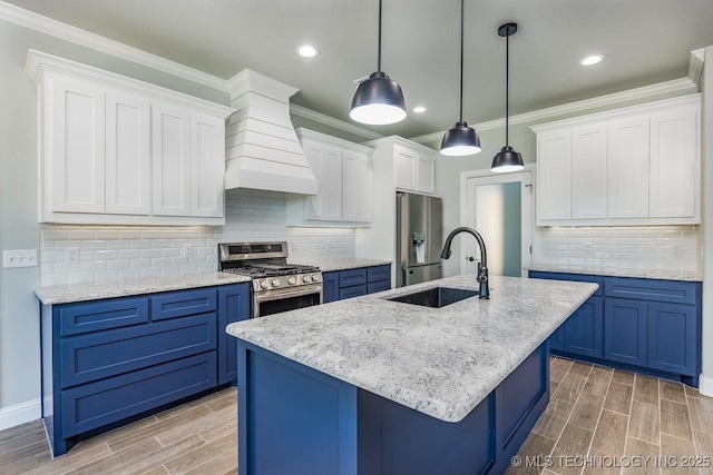 kitchen with sink, custom exhaust hood, white cabinetry, decorative light fixtures, and stainless steel appliances