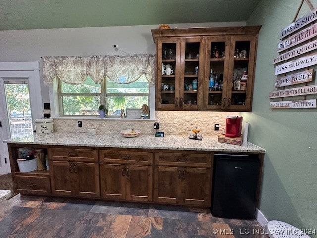 interior space with light stone countertops and dark brown cabinetry