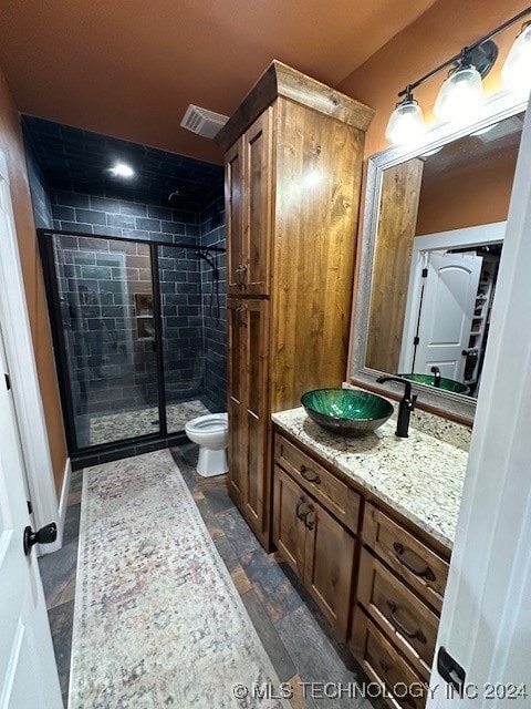 bathroom with vanity, toilet, and walk in shower