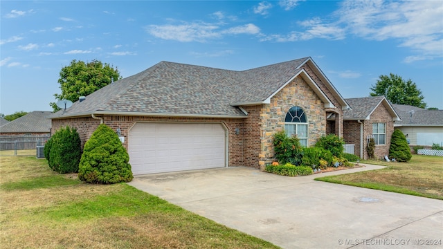 view of front of property featuring a garage and a front lawn