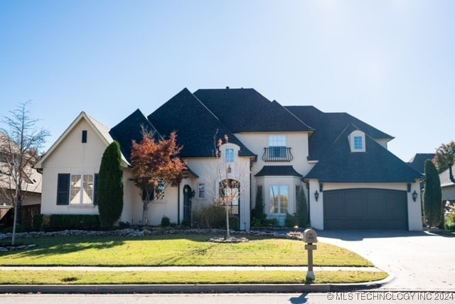 french country inspired facade with a front lawn