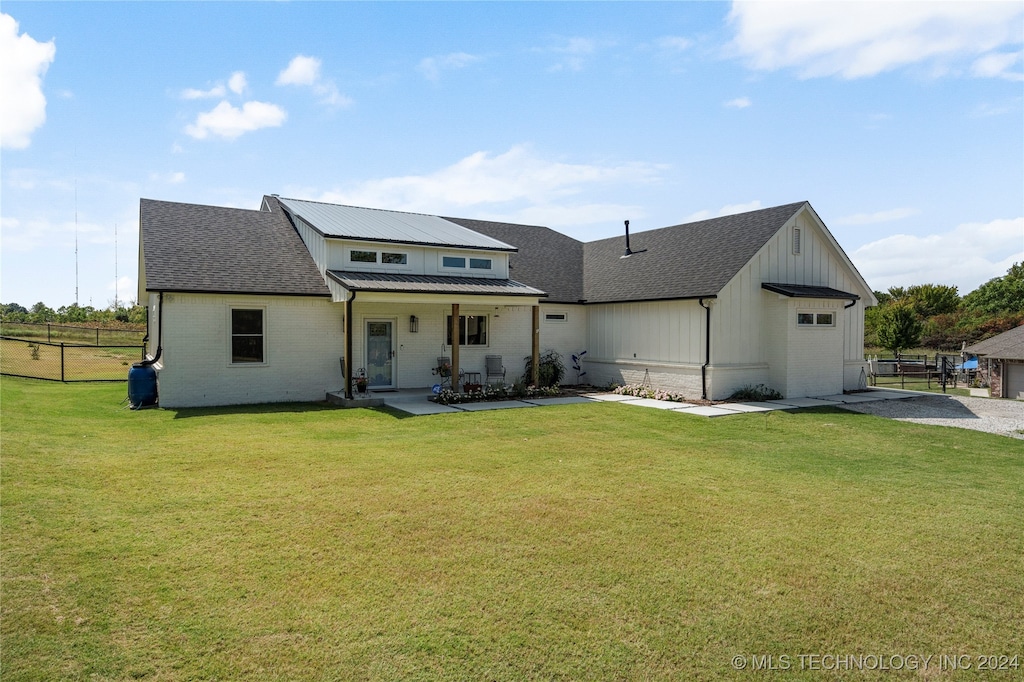 exterior space with a lawn, covered porch, and solar panels