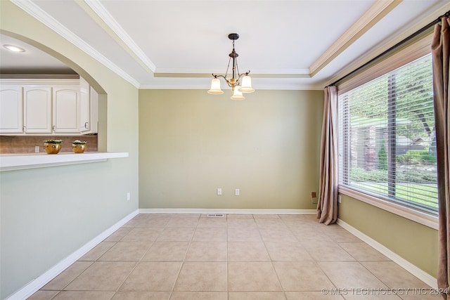 2116 E 59th Pl Unit 4F, Tulsa, OK 74105 - unfurnished dining area featuring a chandelier, a tray ceiling, crown molding, light tile patterned floors, and arched walkways