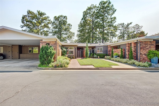 2116 E 59th Pl Unit 4F, Tulsa, OK 74105 - view of front of property featuring brick siding, a carport, and driveway