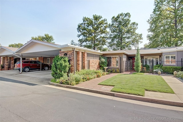 2116 E 59th Pl Unit 4F, Tulsa, OK 74105 - view of front of house with brick siding, an attached carport, and driveway