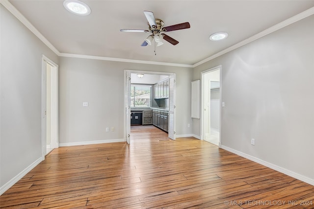 2116 E 59th Pl Unit 4F, Tulsa, OK 74105 - unfurnished living room with ornamental molding, a ceiling fan, and light wood-type flooring