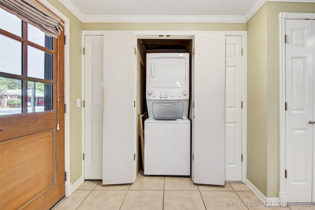 2116 E 59th Pl Unit 4F, Tulsa, OK 74105 - laundry room with stacked washer and clothes dryer, light tile patterned floors, and ornamental molding
