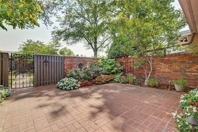 2116 E 59th Pl Unit 4F, Tulsa, OK 74105 - fenced backyard with a gate and a patio area