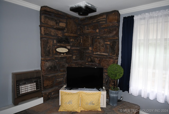 living room with ornamental molding and heating unit