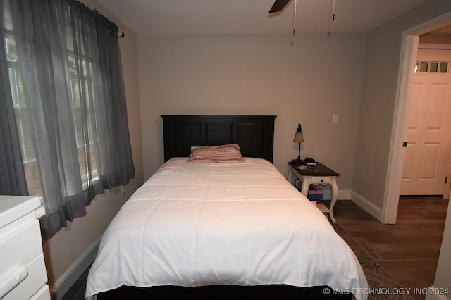 bedroom featuring ceiling fan and dark hardwood / wood-style floors