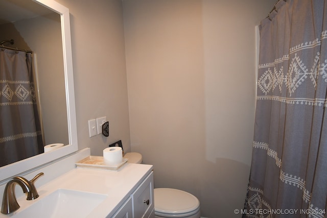 bathroom featuring vanity, toilet, and a shower with shower curtain