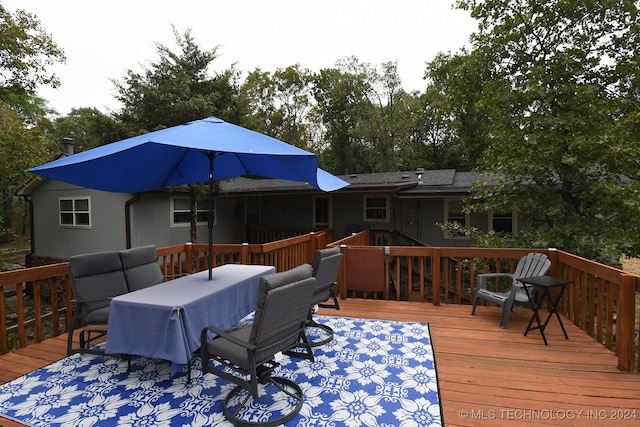 wooden terrace with outdoor lounge area