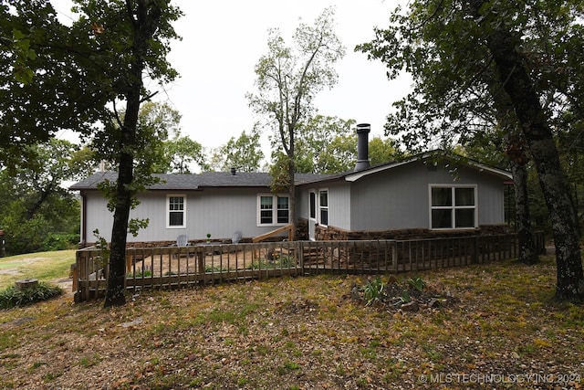 rear view of house with a wooden deck