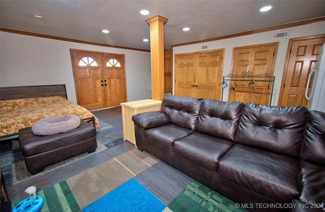 living room featuring ornate columns and crown molding