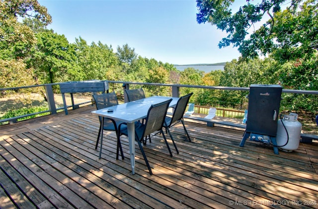 wooden terrace featuring a water view