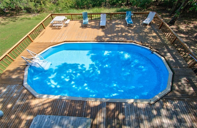 view of swimming pool with a wooden deck