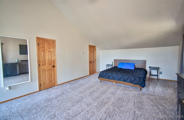 bedroom featuring carpet and vaulted ceiling