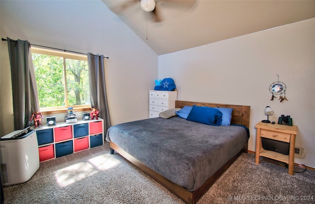 carpeted bedroom with ceiling fan and vaulted ceiling