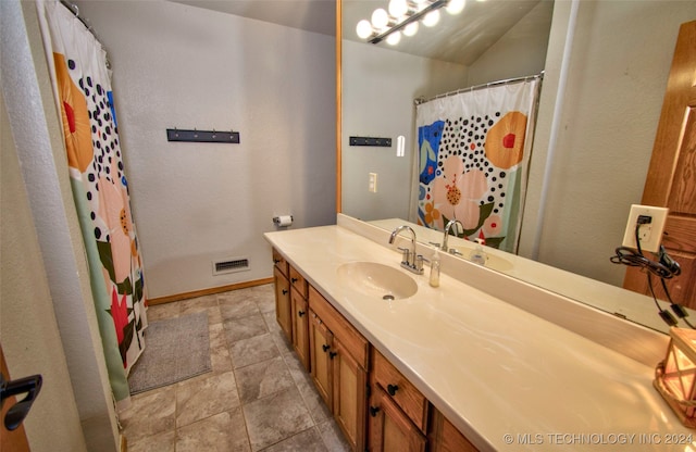 bathroom featuring vanity and curtained shower