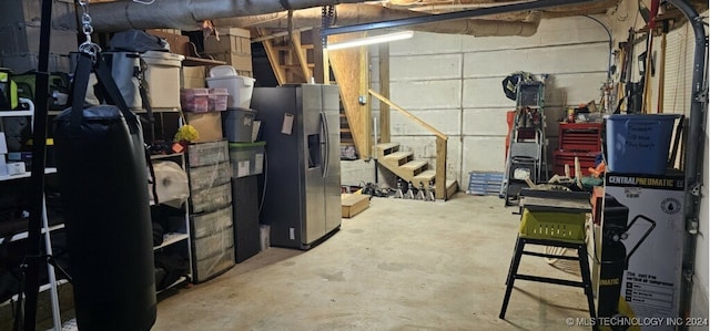 basement featuring stainless steel fridge