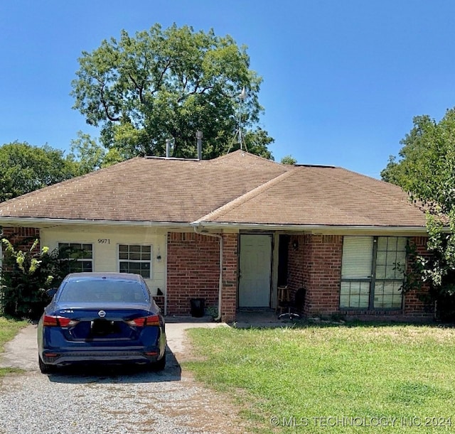 ranch-style home with a front yard