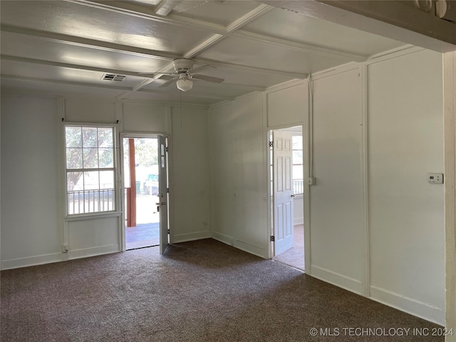 empty room with carpet flooring, ceiling fan, and beamed ceiling