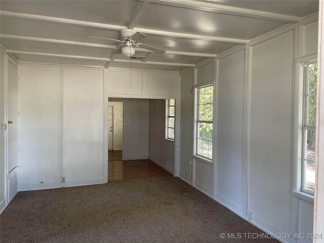 carpeted spare room featuring ceiling fan and a healthy amount of sunlight