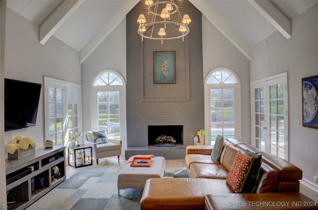 living room with a fireplace, beamed ceiling, a chandelier, and a healthy amount of sunlight