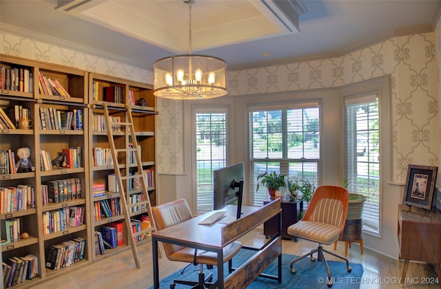 office space with hardwood / wood-style floors, a tray ceiling, plenty of natural light, and a chandelier