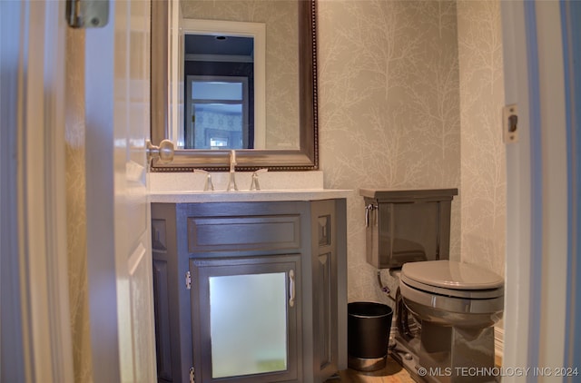 bathroom featuring toilet and vanity