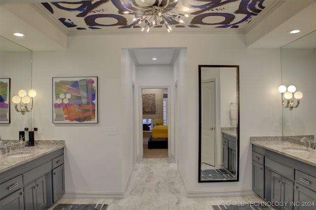 bathroom featuring vanity, ornamental molding, and a notable chandelier