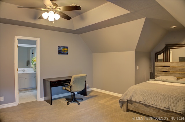 bedroom with light colored carpet, ceiling fan, ensuite bathroom, and vaulted ceiling