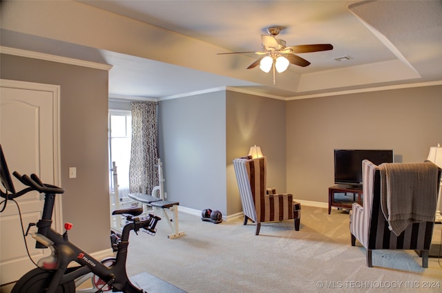 workout area with crown molding, light carpet, and ceiling fan