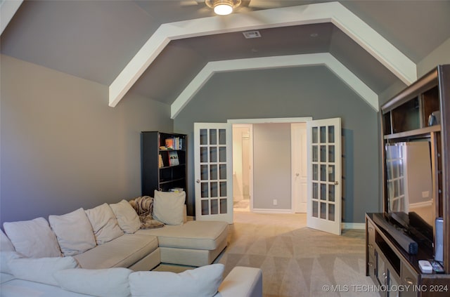 living room featuring light colored carpet, vaulted ceiling, and ceiling fan