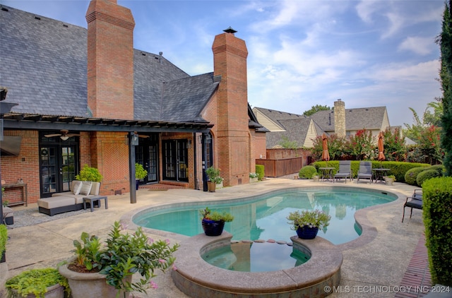 view of pool featuring french doors, a patio, an in ground hot tub, and an outdoor hangout area