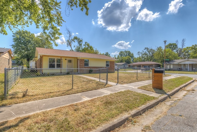 ranch-style house featuring a front lawn