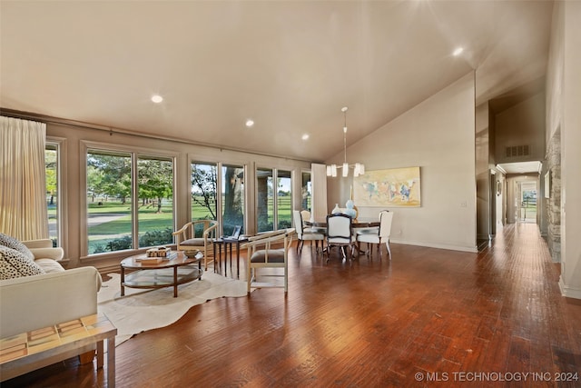 living room featuring high vaulted ceiling and dark hardwood / wood-style flooring